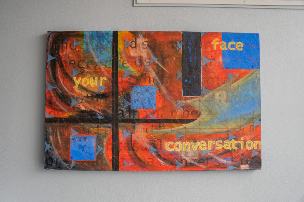 A color block painting with a grid and colored words in the background.